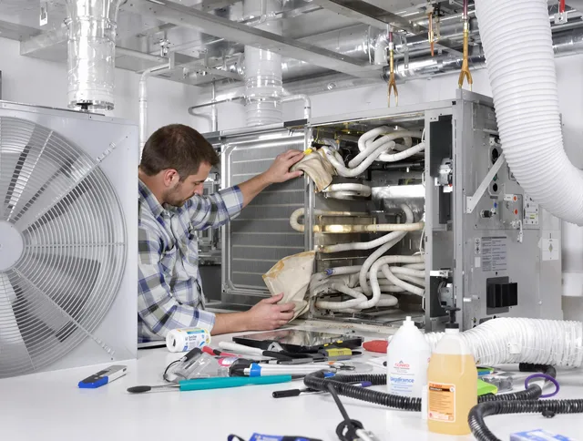 Sudbury Air Duct Cleaning specialist performing precision AC coil cleaning in Sudbury