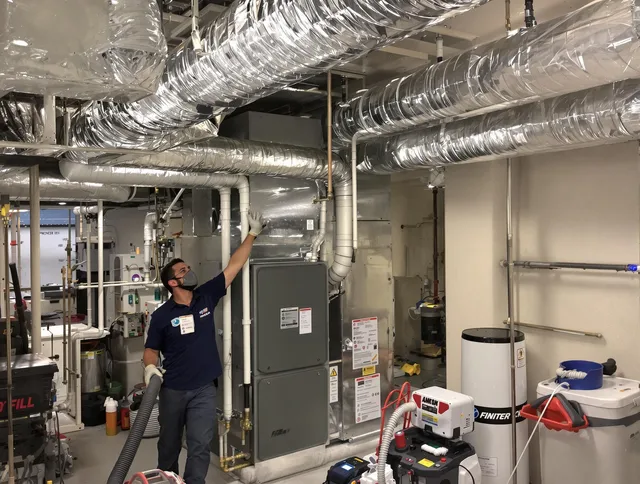 Sudbury Air Duct Cleaning specialist performing thorough furnace duct cleaning in a Sudbury residence