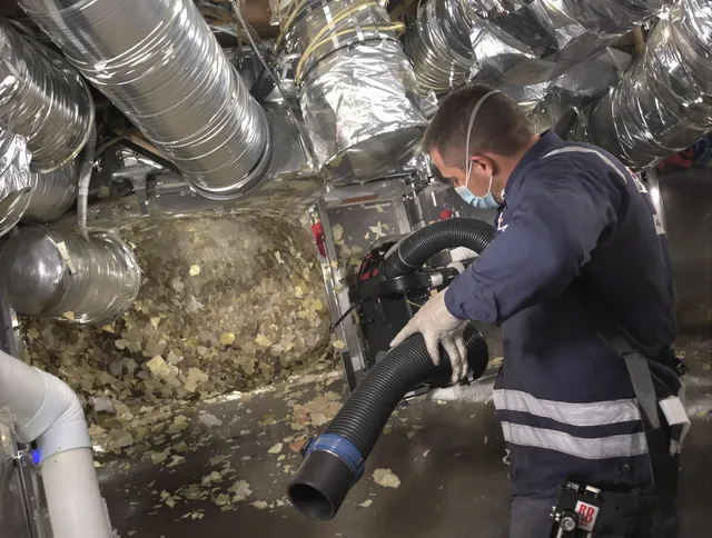 Sudbury Air Duct Cleaning specialist operating negative pressure cleaning equipment for thorough duct maintenance in Sudbury