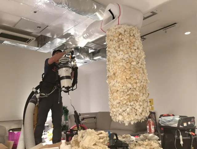 Sudbury Air Duct Cleaning technician performing precision vacuum insulation removal in a residential property in Sudbury